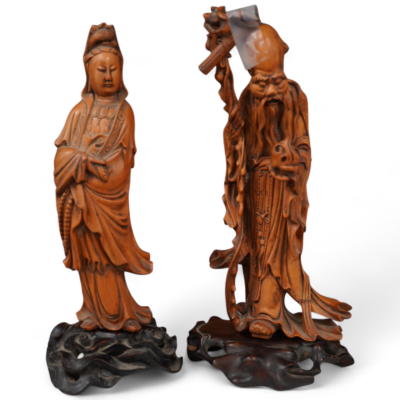 Two Chinese carved boxwood figures, one of Shao Lao, the other of Guan Yin, both on stands, on stands. tallest 26cm